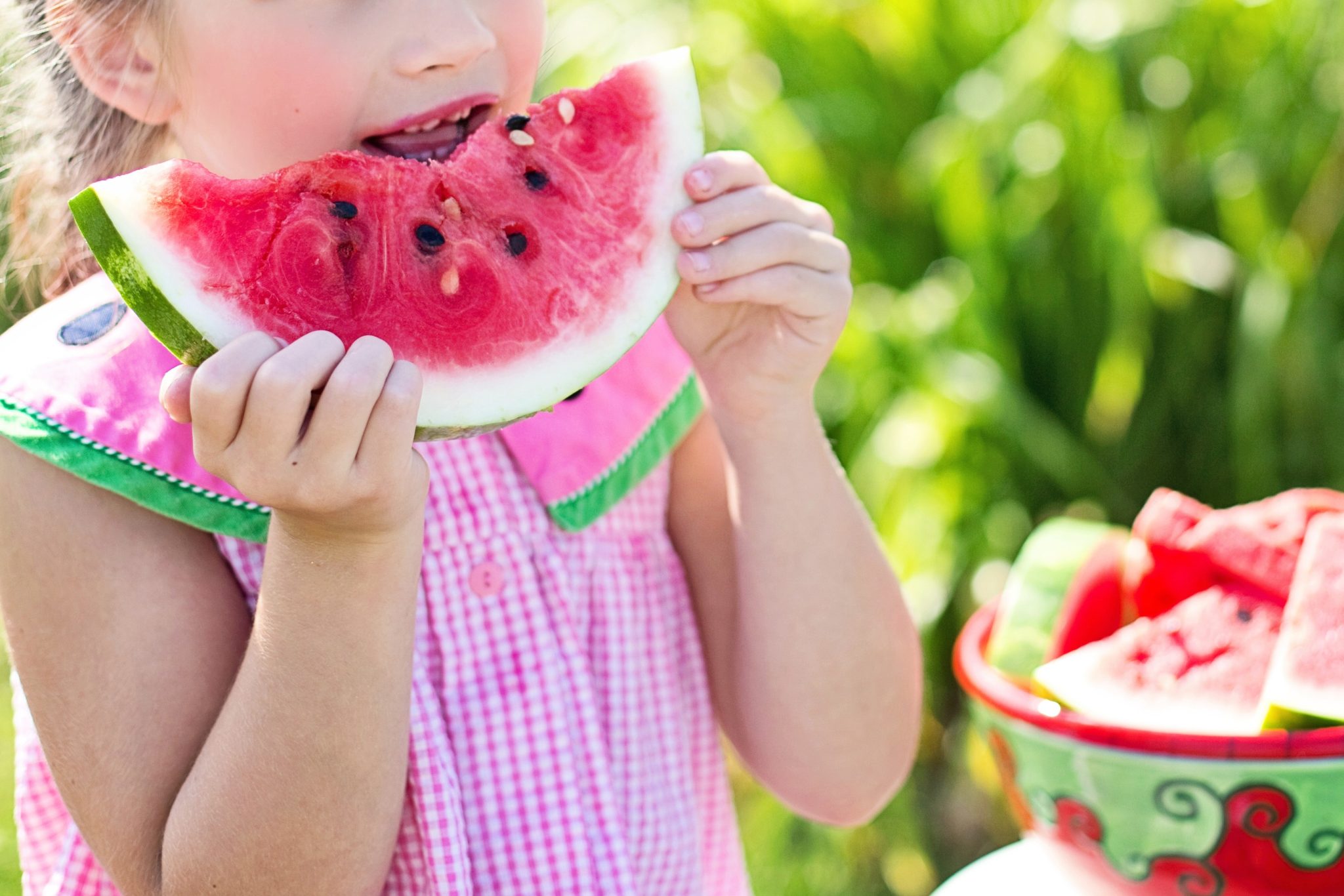 A little girl eating water melon